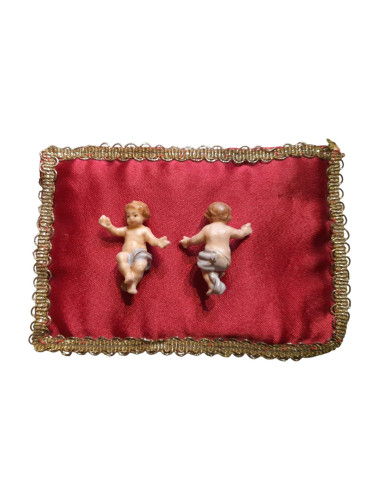 Miniature of lying Jesus Child made in colored wood